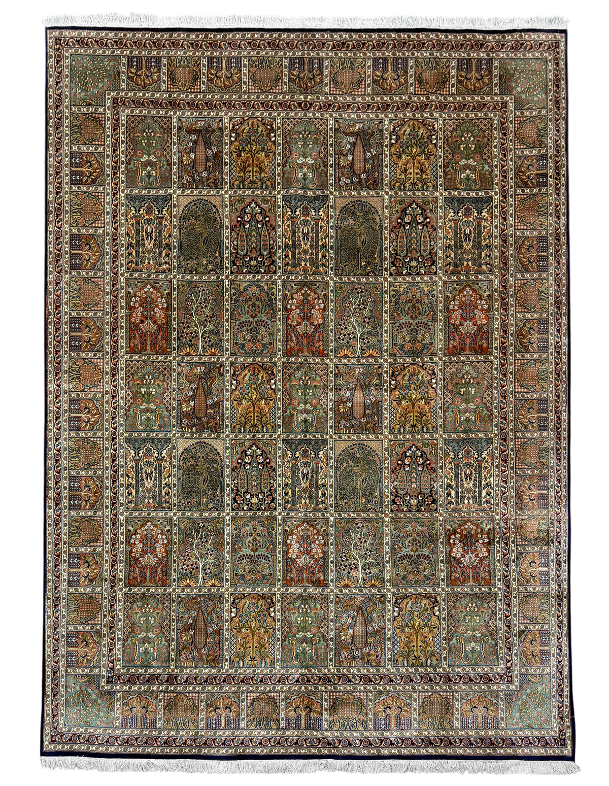 A rectangular traditional area rug with an intricate geometric and floral pattern, featuring a central field of arch motifs in muted earth tones and a decorative border, finished with white fringe on the top and bottom.
